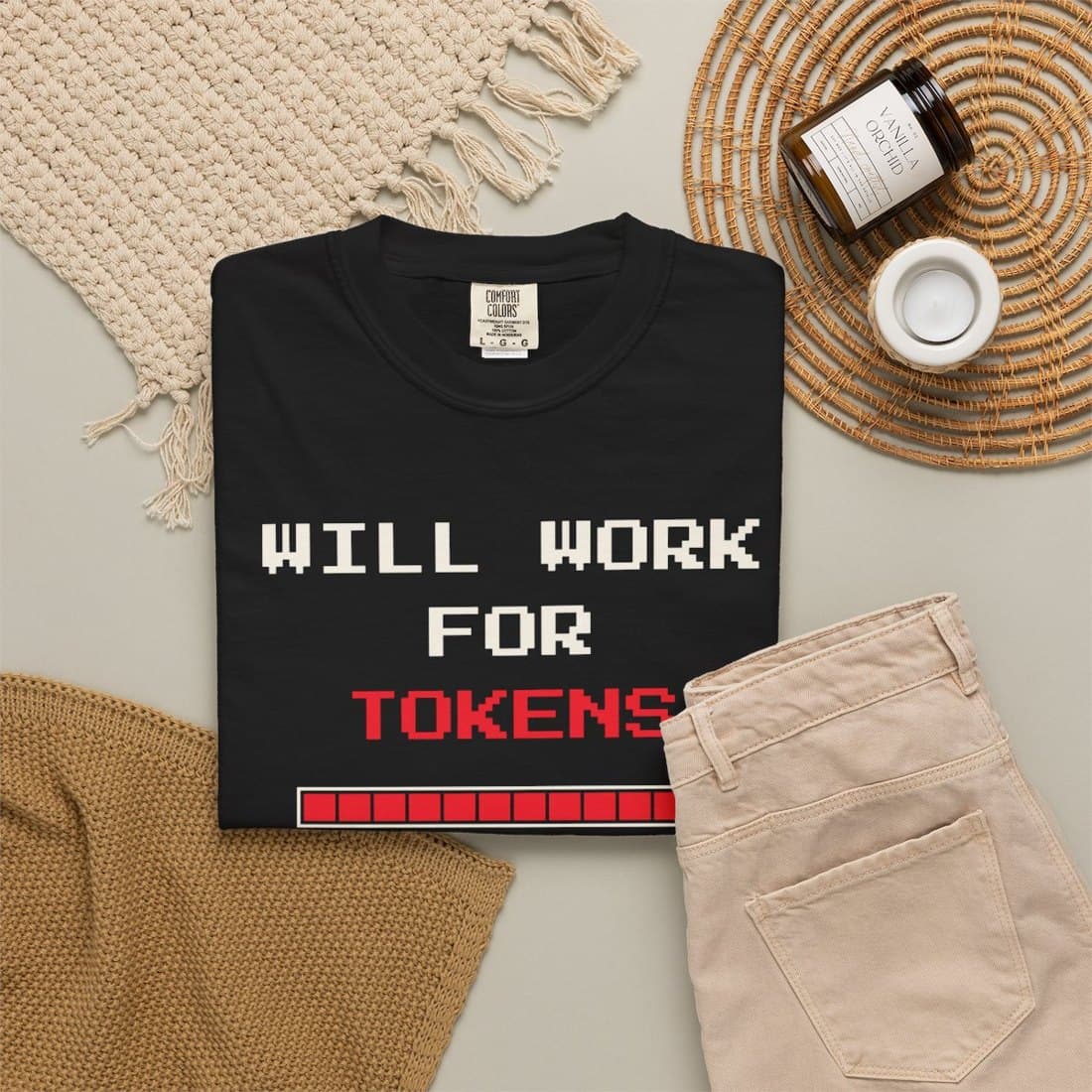 Will Work For Tokens Tee, folded black tee: pixel type reading Will Work For Tokens with a token meter at 100%